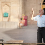 Iranian man looking up to God before prayer